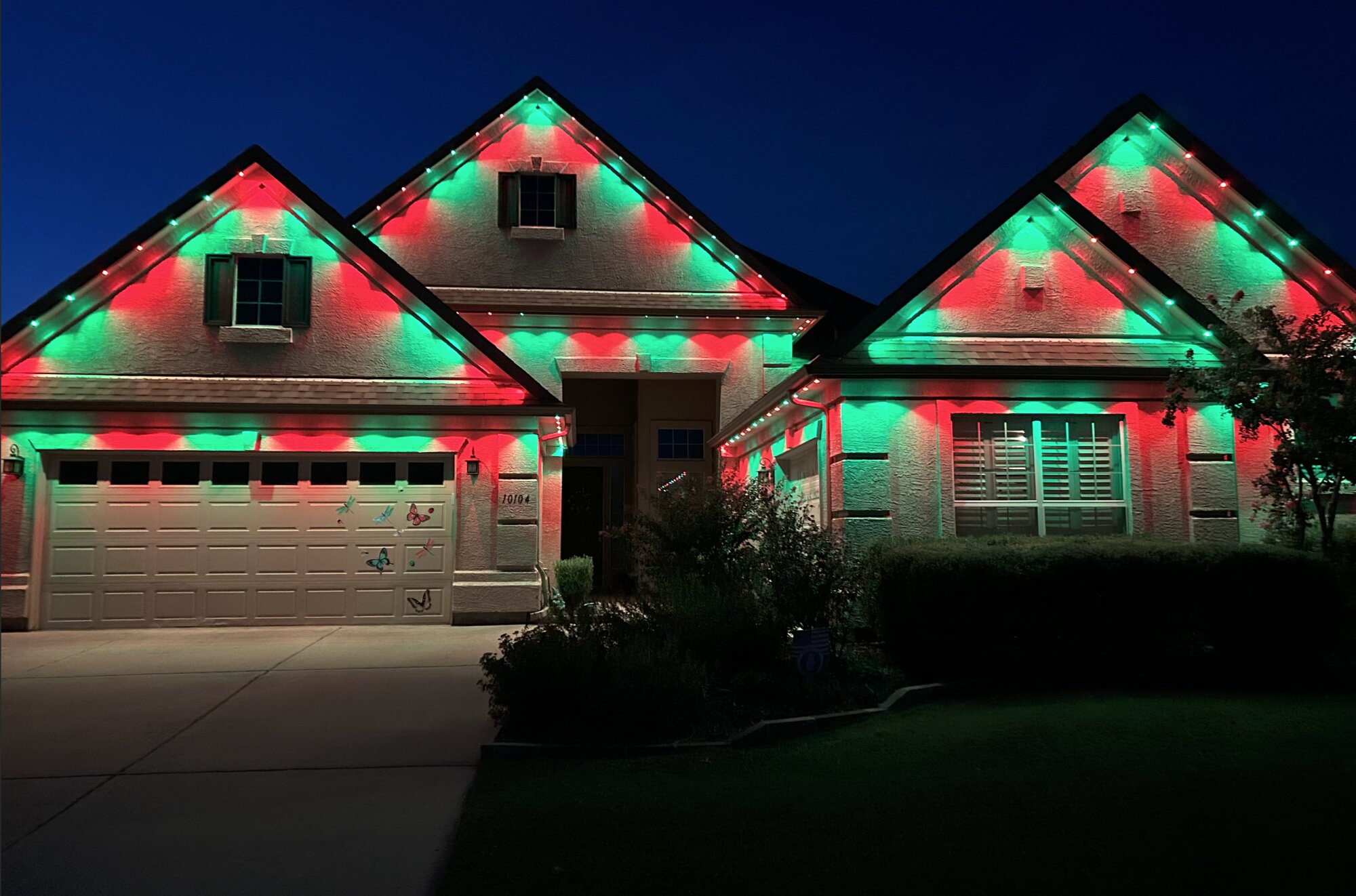 Home with red and green holiday permanent lighting
