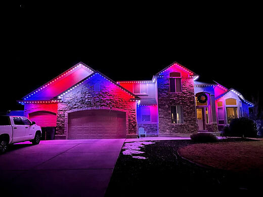 Home with red, white, and blue patriotic permanent lighting