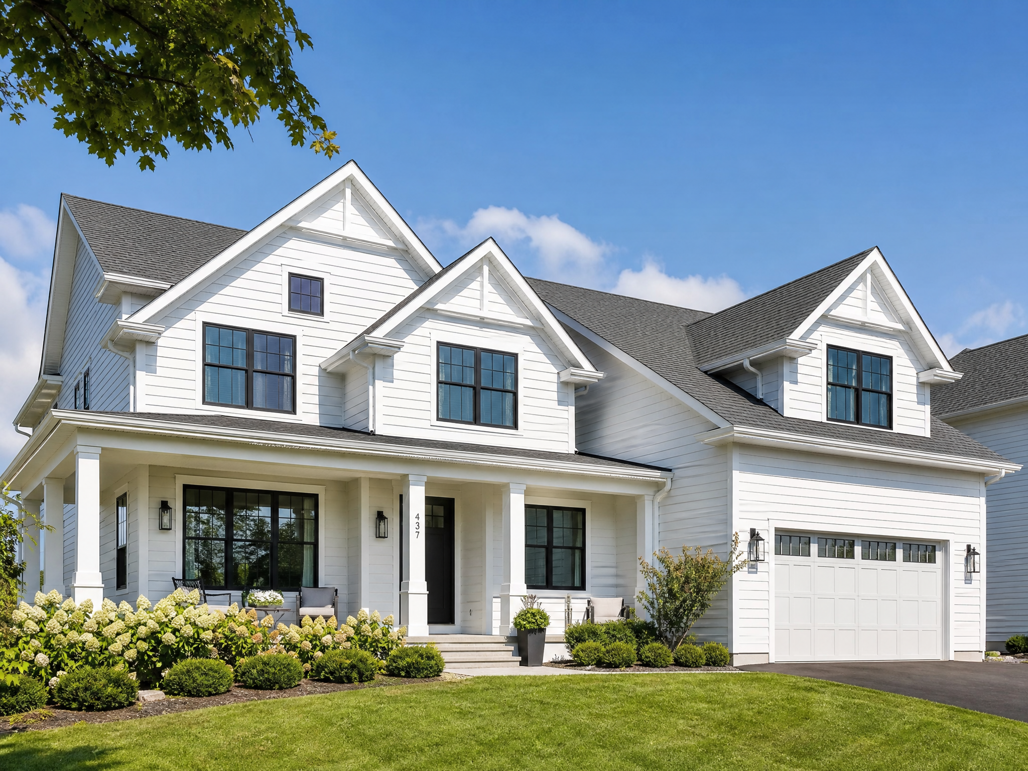 A two-story home in bright daylight with a color-matched aluminum lighting track running along the roofline, nearly invisible with the lights off